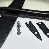 Carbon fiber winglet with screws and small carbon fiber plates on a white background